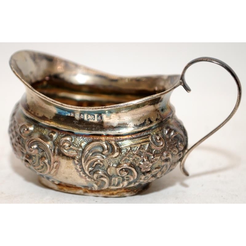 169 - A collection of hallmarked silver items to include a cased pair of napkin rings, a small creamer and... 