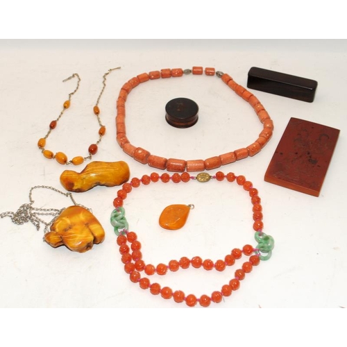 132 - A collection of Chinese amber to include bracelet, pendant, two wood cased items and an amber plaque... 