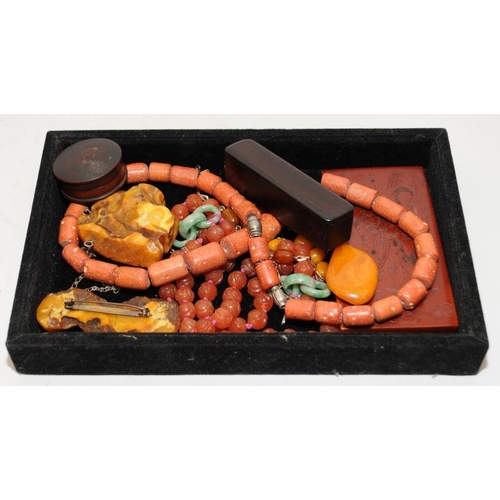 132 - A collection of Chinese amber to include bracelet, pendant, two wood cased items and an amber plaque... 