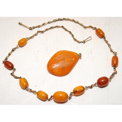 132 - A collection of Chinese amber to include bracelet, pendant, two wood cased items and an amber plaque... 