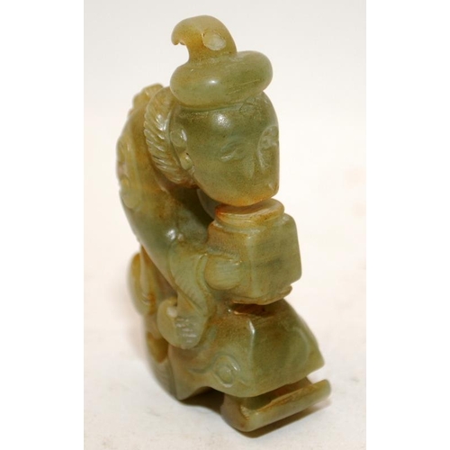 153 - A small jade carved Oriental figure of a scholar. 5cms tall