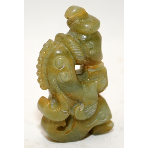 153 - A small jade carved Oriental figure of a scholar. 5cms tall