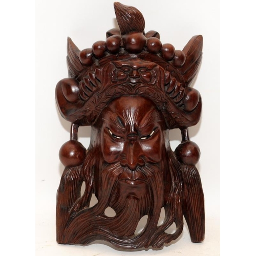 400 - Two vintage carved hardwood Oriental wallhanging face masks. The largest being 30cms