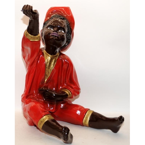 402 - Large gloss painted figure of a sitting Nubian boy, smartly dressed with outstretched hand. Probably... 