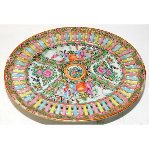 100A - Vintage Oriental Famille Rose oval plate with pierced border around painted scenes. 27cms across