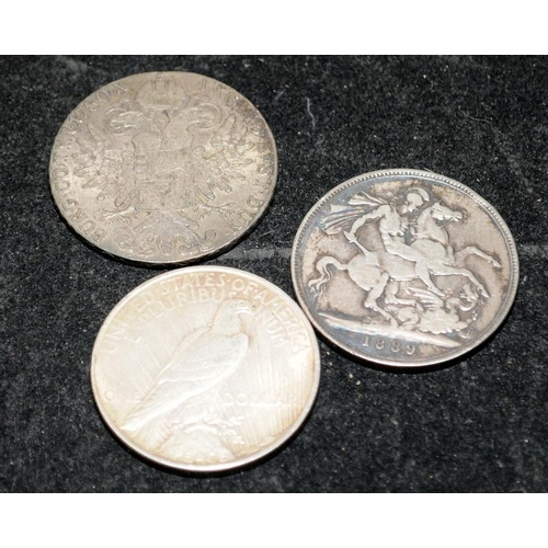 304 - Three silver coins to include an 1889 Victorian Crown, a 1922 Peace Dollar and a Maria Theresa Thale... 