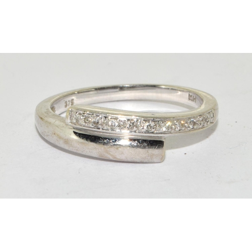 266 - White gold Diamond twist ring in 9ct size O