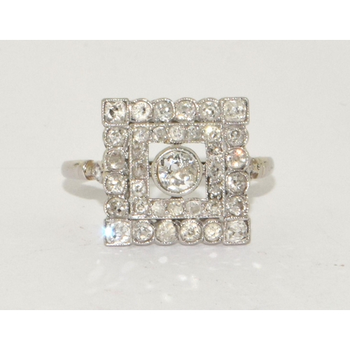 78 - Art Deco design Square cut Diamond ring with raised centre of old Diamond and 16 small grain set old... 