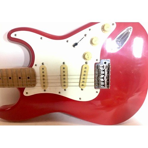 452 - SQUIER FENDER STRATOCASTER. Finished in bright red and missing a couple of strings. Their are some a... 