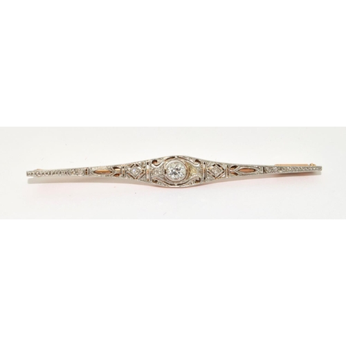 69 - Antique Art Deco Diamond gold and platinum bar brooch. Set with central round cut Diamonds and other... 