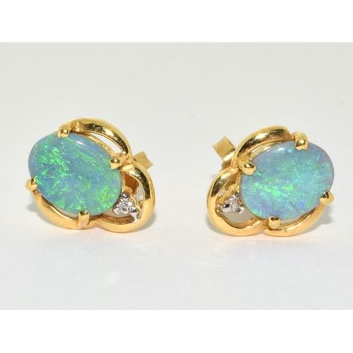 82 - Opal fire and diamond 18ct gold earrings (boxed).