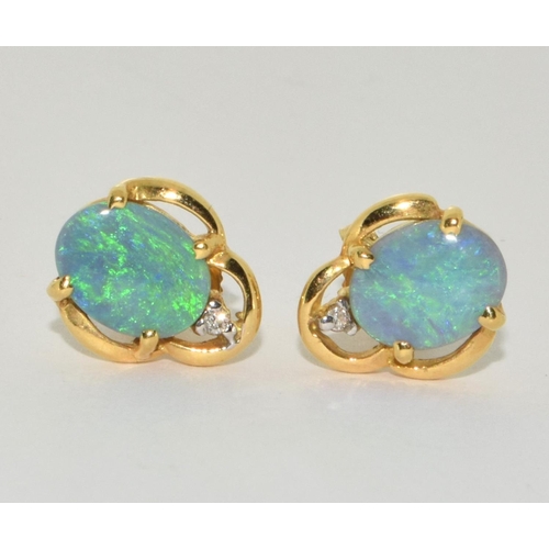 82 - Opal fire and diamond 18ct gold earrings (boxed).