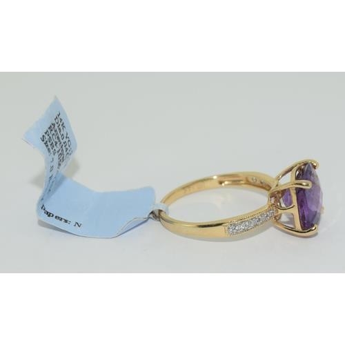 148 - 14ct gold ladies new with tags Amethyst and Diamond ring size N tag price $2400