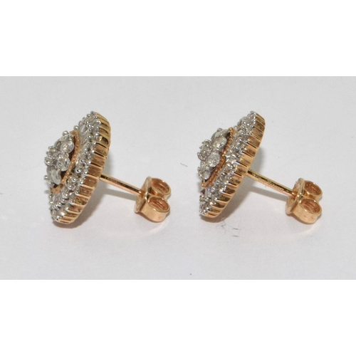 506 - 9ct gold Diamond earrings set in the round halo design with round and baguette stones 1 missing