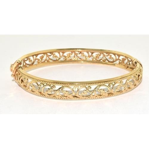 450 - 9ct gold open work bangle with spring closed mechanism, 9.3g