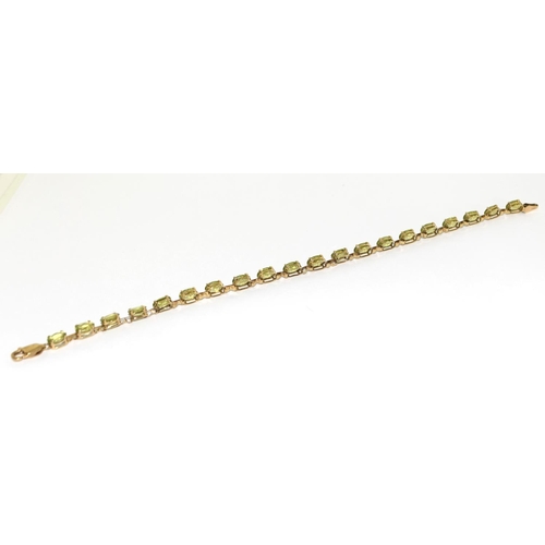 322 - 9ct gold and natural peridot line bracelet 7