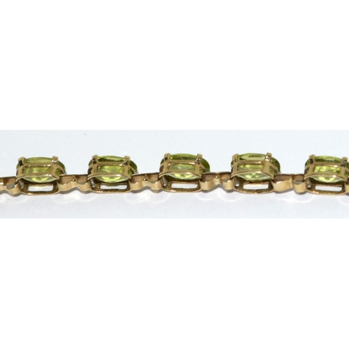 322 - 9ct gold and natural peridot line bracelet 7