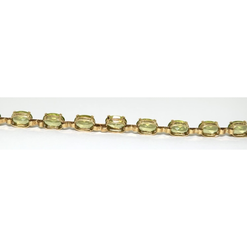 322 - 9ct gold and natural peridot line bracelet 7