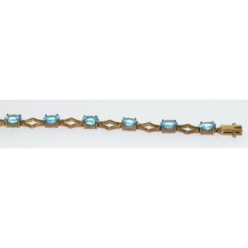 507 - 9ct gold and blue topaz line bracelet 71/2 