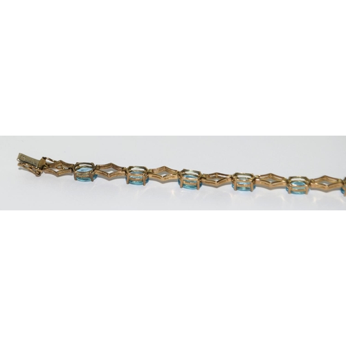 507 - 9ct gold and blue topaz line bracelet 71/2 