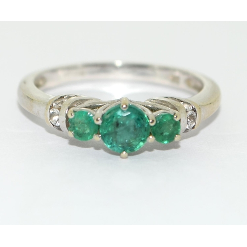 466 - Emerald and diamond trilogy ring in 9ct white gold Size O.