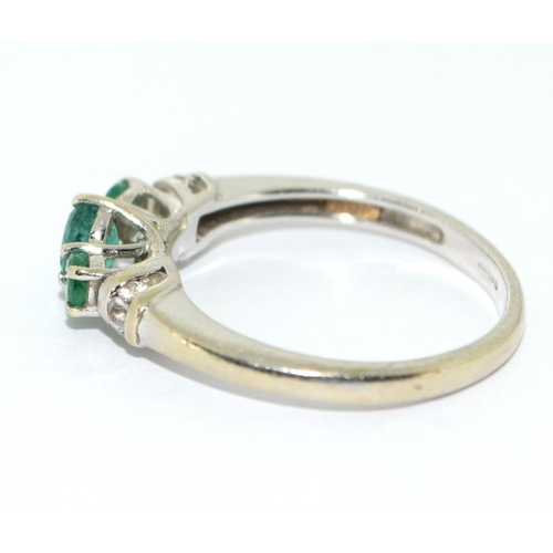 466 - Emerald and diamond trilogy ring in 9ct white gold Size O.