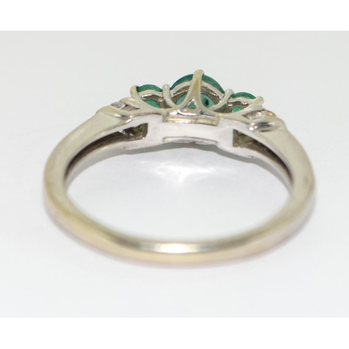 466 - Emerald and diamond trilogy ring in 9ct white gold Size O.