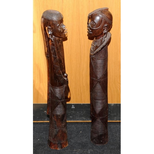 148 - Large floor standing wooden carved figures of an African male and female. Possible fertility connota... 