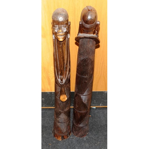 148 - Large floor standing wooden carved figures of an African male and female. Possible fertility connota... 