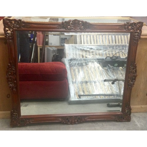 563 - Modern mahogany bevelled edged decorative mirror 111x90cm.