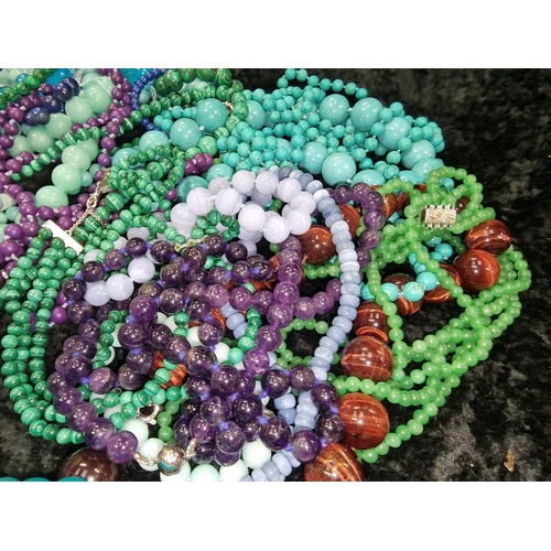 409 - Large quantity of beaded necklaces and bracelets to include Malachite, Jadeite, and Tourquoise