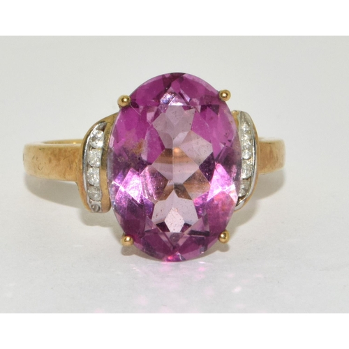 276 - A 9ct gold ladies Amethyst sweep ring set, with Diamond chip shoulders 
Size O