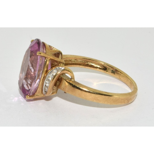 276 - A 9ct gold ladies Amethyst sweep ring set, with Diamond chip shoulders 
Size O