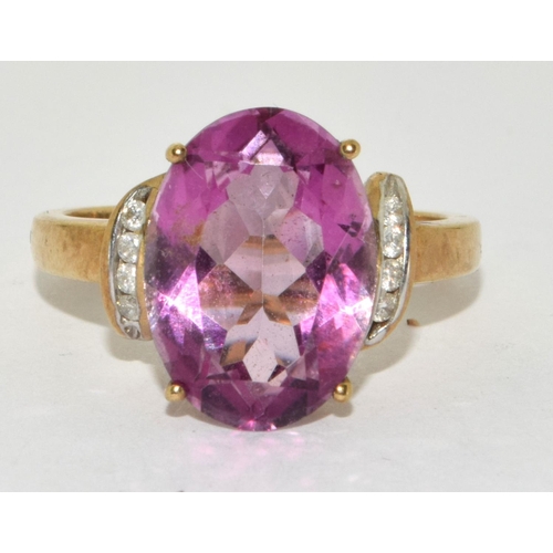 276 - A 9ct gold ladies Amethyst sweep ring set, with Diamond chip shoulders 
Size O