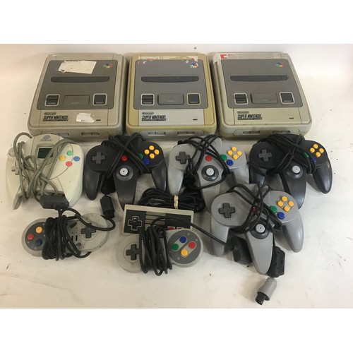 89 - Box of 3 Super Nintendo game entertainment systems along with various hand held controllers.