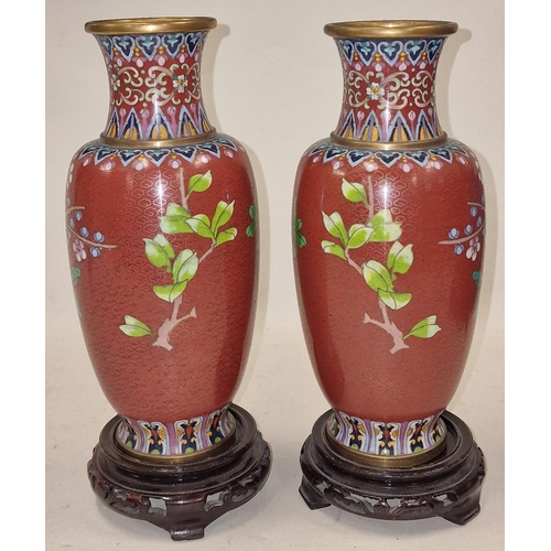 199 - Pair of Cloisonne vases standing on wooden bases 26cm tall