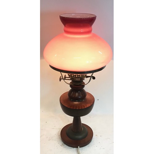 105 - Vintage style lamp standing on wood turned base with glass pink shade. Stands 48cm high.