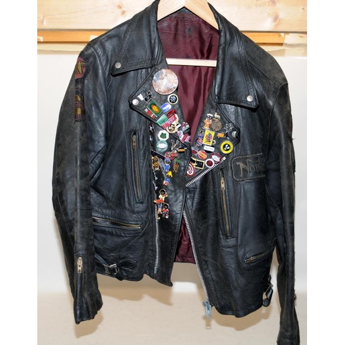 119 - Vintage leather motorbike jacket with a collection of metal badges to include gollies. pit to pit ac... 