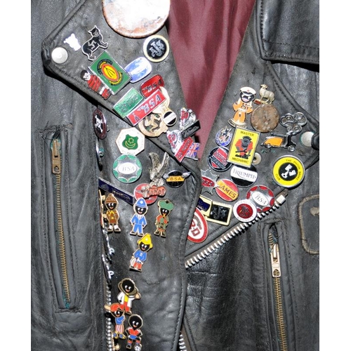 119 - Vintage leather motorbike jacket with a collection of metal badges to include gollies. pit to pit ac... 