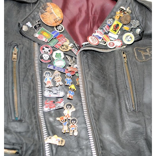 119 - Vintage leather motorbike jacket with a collection of metal badges to include gollies. pit to pit ac... 