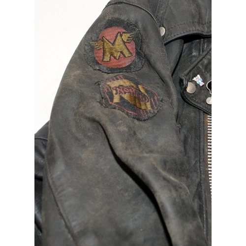 119 - Vintage leather motorbike jacket with a collection of metal badges to include gollies. pit to pit ac... 