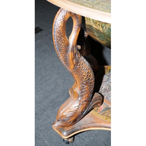 552 - Globe high top drinks cabinet standing on a turned center support with carved Dolphins to each corne... 