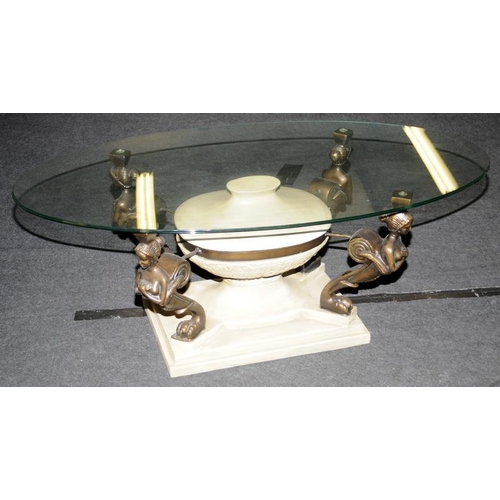 576 - Oval Glass top coffee table set on quatrefoil supports depicting maidens 45x120x60cm