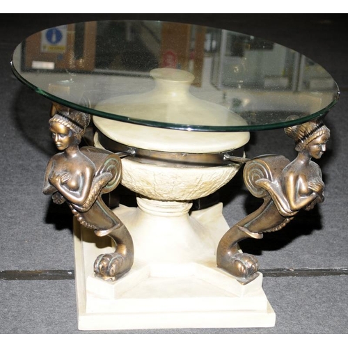 576 - Oval Glass top coffee table set on quatrefoil supports depicting maidens 45x120x60cm