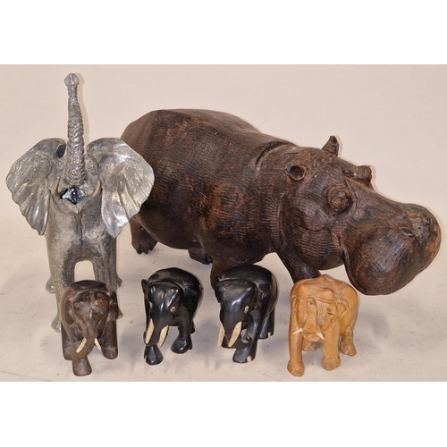 147 - Mixed size carved African Elephants to include a large metal item together a carved Hippo