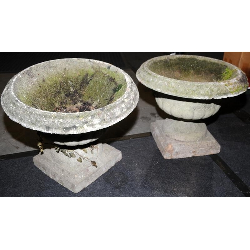 245 - A pair of vintage reconstituted concrete garden urns. One requires restoration.