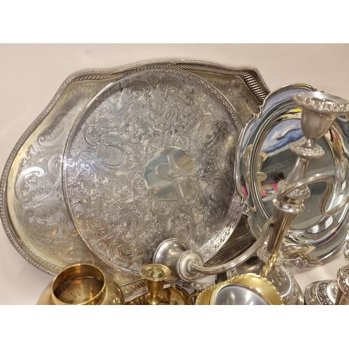 185 - Collection of silver plated and brassware items to include serving trays and candlesticks.