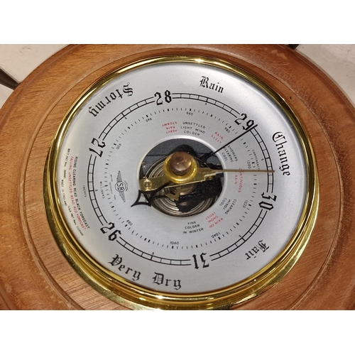 82 - Two vintage wooden biscuit barrels together with a wooden ships wheel barometer (3).