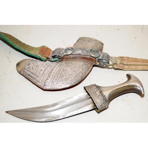 138 - Vintage ornate ceremonial Arab Jambiya double edged curved dagger and belt in a silver sheath.