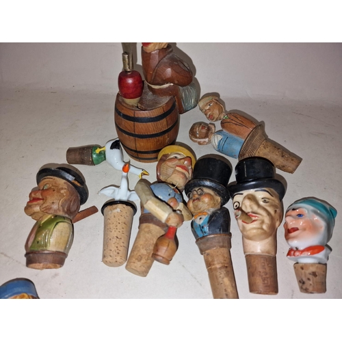 102 - Collection of vintage novelty bottle stoppers constructed of wood and porcelain (15).